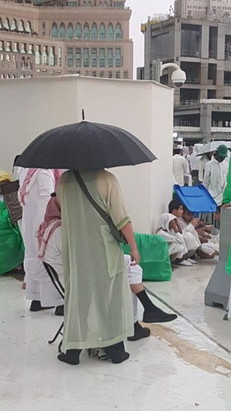 بالصور.. الأمطار تنعش زائروا البيت الحرام