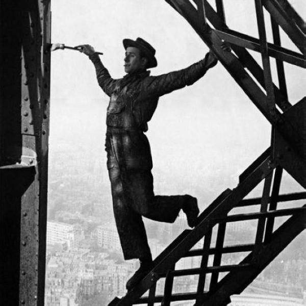 أحد الرسامين أثناء عملية طلاء لبرج إيفل عام 1953 - مشاع إبداعي