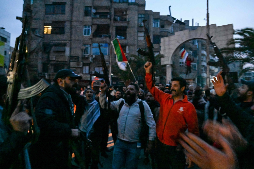  احتفالات في دمشق بسقوط نظام الرئيس بشار الأسد - أ ف ب