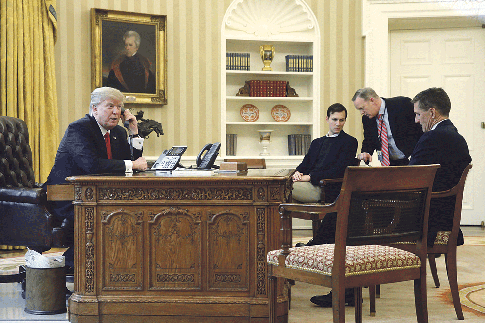
ترامب أثناء اتصاله بخادم الحرمين الشريفين ويحيط به كبار مساعديه ( رويترز)
